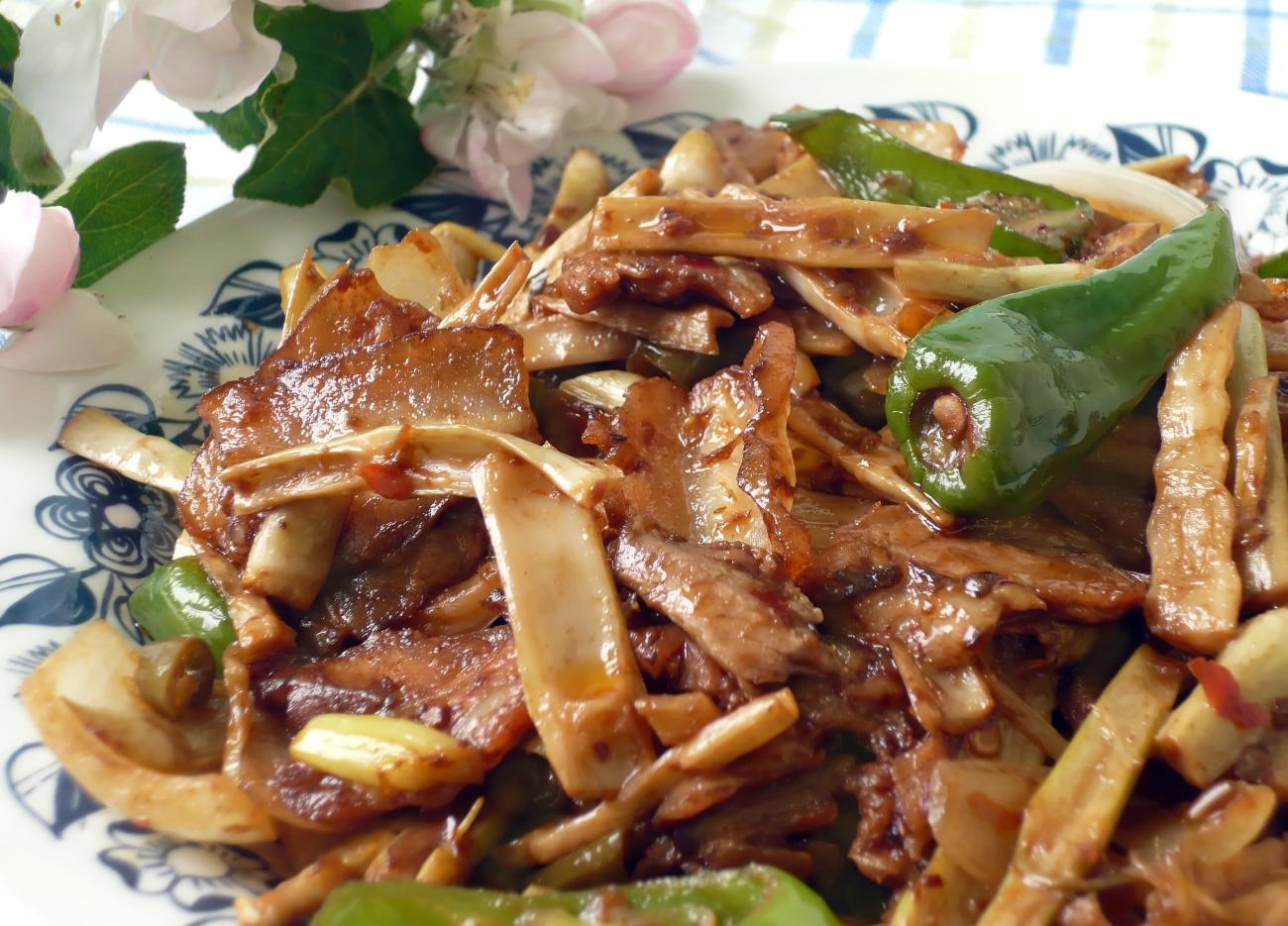 Closeup of traditional Chinese dish, twice cooked pork with peppers